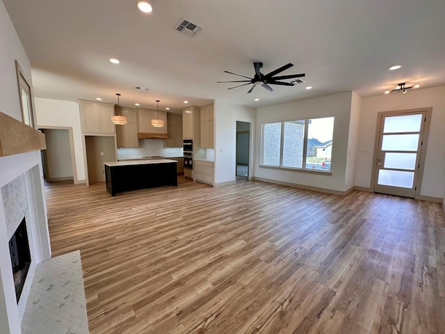 unfurnished living room featuring visible vents, recessed lighting, a fireplace, and ceiling fan