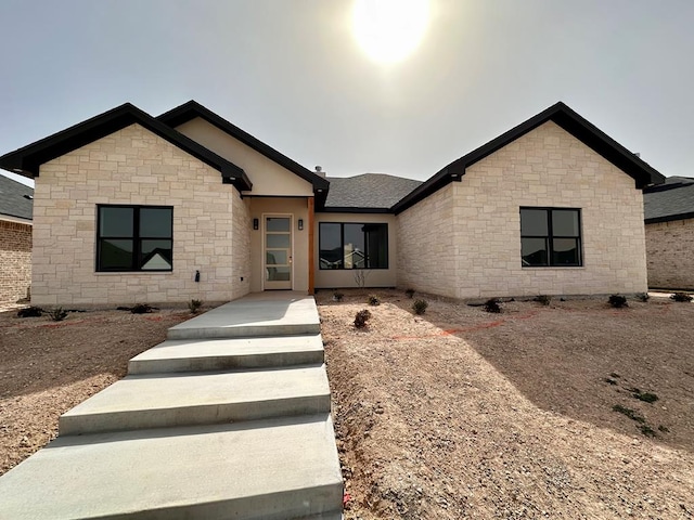 view of front of house featuring a shingled roof