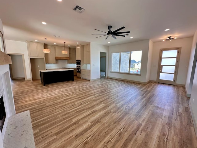 kitchen featuring tasteful backsplash, visible vents, and open floor plan