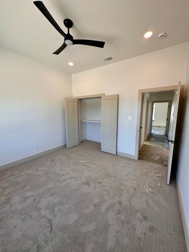 unfurnished bedroom featuring recessed lighting, carpet flooring, baseboards, and visible vents