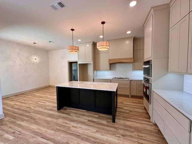 kitchen with light wood-type flooring, visible vents, tasteful backsplash, appliances with stainless steel finishes, and custom exhaust hood