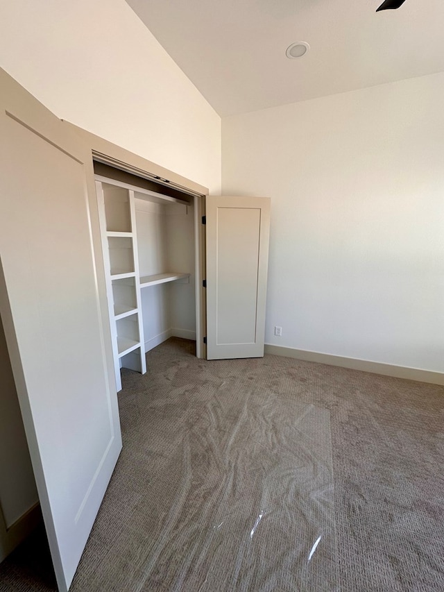 unfurnished bedroom with baseboards and carpet flooring