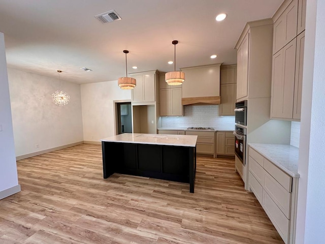 kitchen featuring visible vents, light wood-style flooring, decorative backsplash, and stainless steel gas cooktop