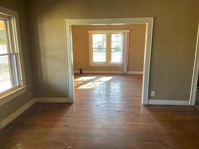 unfurnished room with dark hardwood / wood-style floors