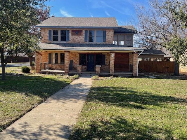 view of front of property with a front yard and covered porch