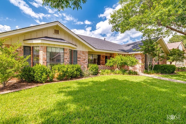 3222 Oak Mountain Trl, San Angelo, TX 76904 - ranch-style house featuring brick siding, a front yard, board and batten siding, and a shingled roof