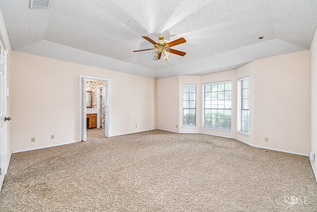 3222 Oak Mountain Trl, San Angelo, TX 76904 - empty room with carpet, ceiling fan, a tray ceiling, and a textured ceiling