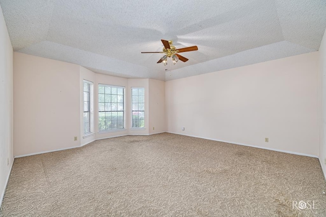 3222 Oak Mountain Trl, San Angelo, TX 76904 - spare room featuring a ceiling fan, carpet floors, a textured ceiling, and a raised ceiling