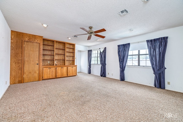 3222 Oak Mountain Trl, San Angelo, TX 76904 - unfurnished living room with a ceiling fan, carpet, and a textured ceiling