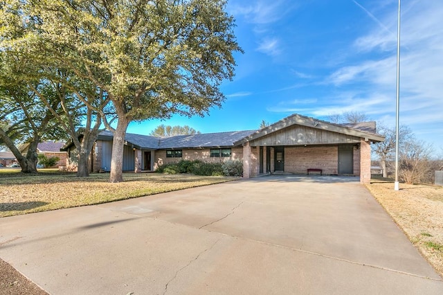 single story home featuring concrete driveway and an attached garage