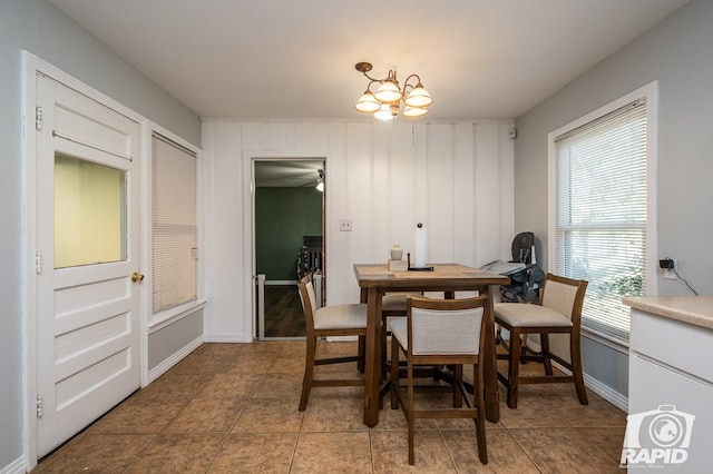 tiled dining space featuring an inviting chandelier