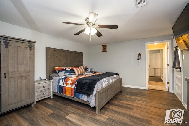 bedroom with dark hardwood / wood-style flooring and ceiling fan