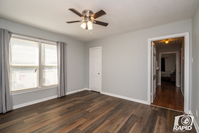 unfurnished bedroom featuring dark hardwood / wood-style floors and ceiling fan