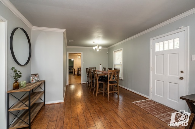 dining area featuring a notable chandelier, ornamental molding, dark hardwood / wood-style floors, and a healthy amount of sunlight