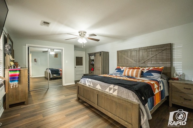 bedroom with dark hardwood / wood-style flooring and ceiling fan