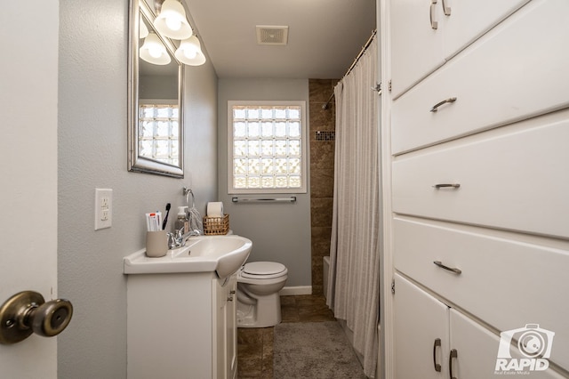 full bathroom with vanity, shower / tub combo with curtain, and toilet