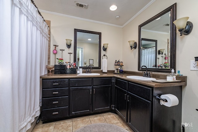 bathroom featuring crown molding, tile patterned floors, and vanity