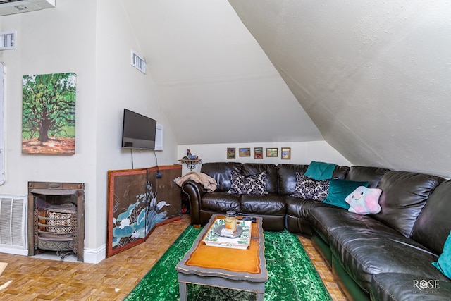 living room featuring lofted ceiling, parquet floors, a fireplace, and a textured ceiling