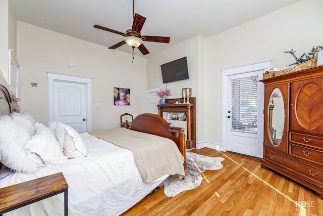 bedroom featuring ceiling fan, light hardwood / wood-style floors, and access to outside