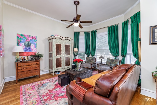 living room with hardwood / wood-style floors, crown molding, and ceiling fan