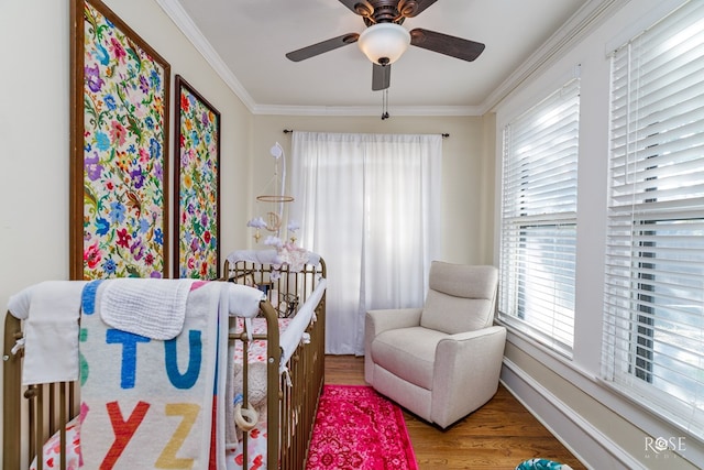 bedroom with crown molding, ceiling fan, and hardwood / wood-style floors