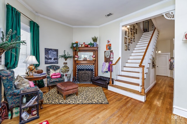 sitting room featuring crown molding and hardwood / wood-style floors