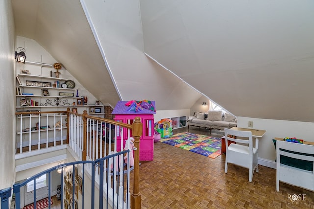 game room with parquet floors, lofted ceiling, and built in shelves