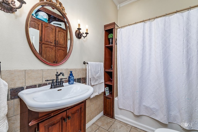 bathroom with tile walls, tile patterned flooring, vanity, shower / tub combo, and crown molding