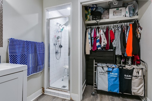 419E 29th St, San Angelo, TX 76903 - bathroom with baseboards, a shower stall, vanity, and wood finished floors