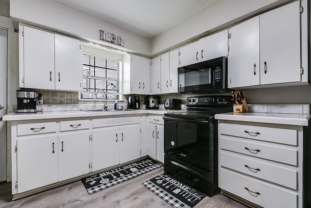 419E 29th St, San Angelo, TX 76903 - kitchen with black appliances, light countertops, a sink, light wood finished floors, and decorative backsplash