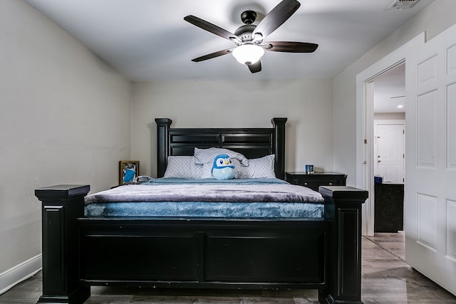 419E 29th St, San Angelo, TX 76903 - bedroom with visible vents, baseboards, a ceiling fan, and wood finished floors