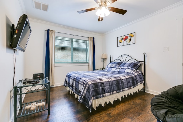 bedroom featuring baseboards, visible vents, a ceiling fan, ornamental molding, and wood finished floors