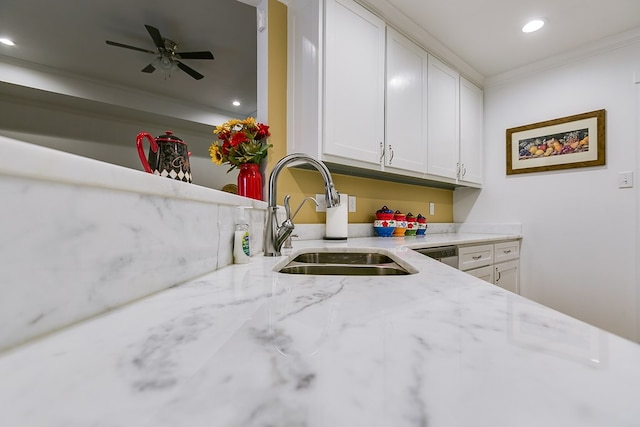 kitchen featuring light stone counters, recessed lighting, a sink, white cabinetry, and crown molding