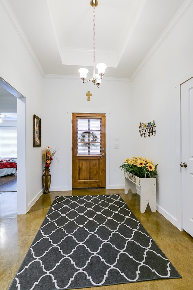 entryway featuring a chandelier, a raised ceiling, finished concrete flooring, and baseboards