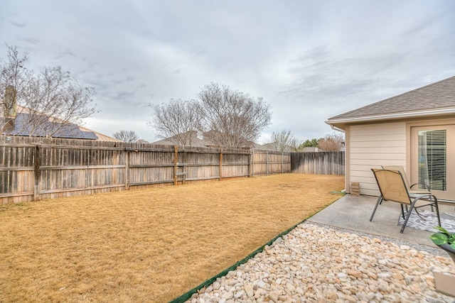 view of yard featuring a patio area and a fenced backyard