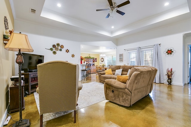 living room featuring ceiling fan with notable chandelier, visible vents, a raised ceiling, and recessed lighting