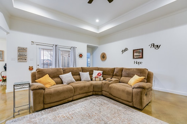 living room with ornamental molding, a raised ceiling, a ceiling fan, and baseboards