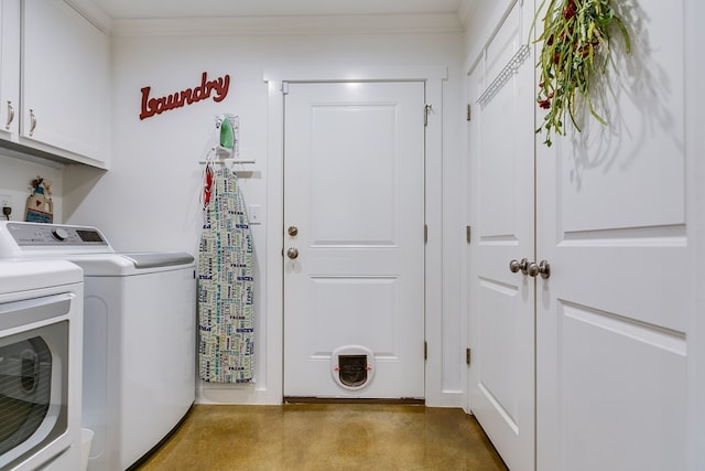 washroom featuring cabinet space, ornamental molding, and washer and dryer