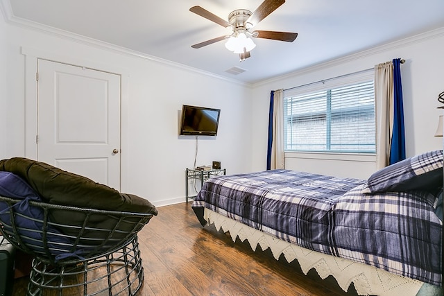 bedroom featuring ornamental molding, a ceiling fan, visible vents, and wood finished floors