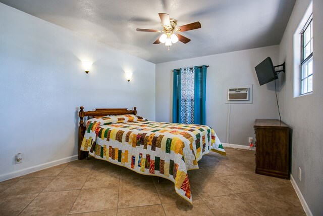 220 Mcdowell St, Bronte, TX 76933 - tiled bedroom featuring a ceiling fan and an AC wall unit