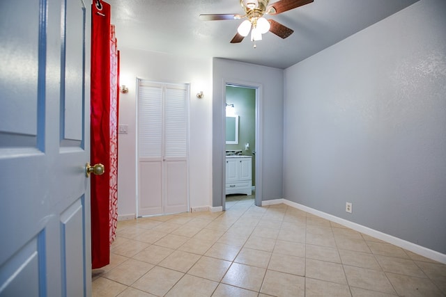 220 Mcdowell St, Bronte, TX 76933 - unfurnished bedroom with light tile patterned floors and ceiling fan