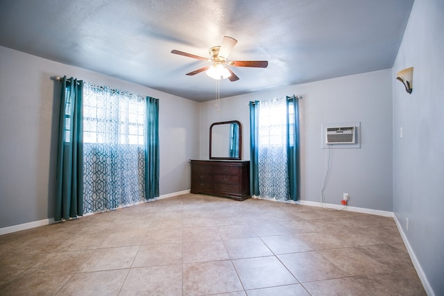 220 Mcdowell St, Bronte, TX 76933 - unfurnished room featuring an AC wall unit, a ceiling fan, and light tile patterned floors