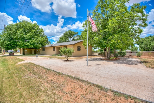 220 Mcdowell St, Bronte, TX 76933 - rear view of property with stucco siding and driveway