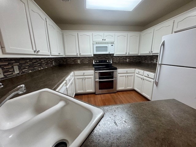 55 Southridge Dr, San Angelo, TX 76904 - kitchen featuring white appliances, a sink, white cabinets, and tasteful backsplash