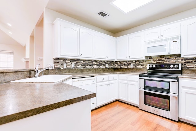 55 Southridge Dr, San Angelo, TX 76904 - kitchen with white appliances, white cabinets, a sink, backsplash, and light wood-style floors