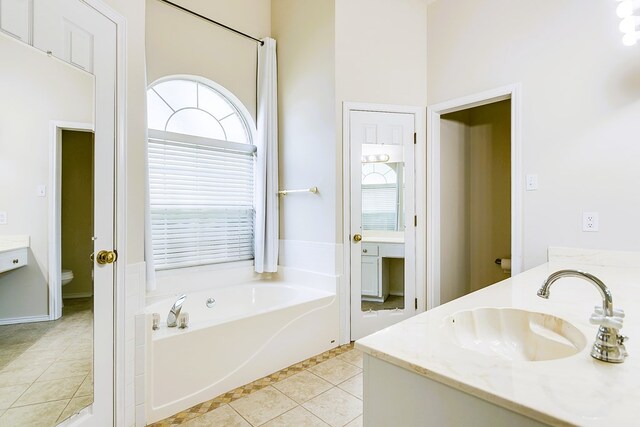 55 Southridge Dr, San Angelo, TX 76904 - bathroom featuring double vanity, a bath, plenty of natural light, and tile patterned floors