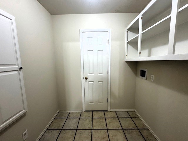 55 Southridge Dr, San Angelo, TX 76904 - laundry area featuring washer hookup, baseboards, and tile patterned floors