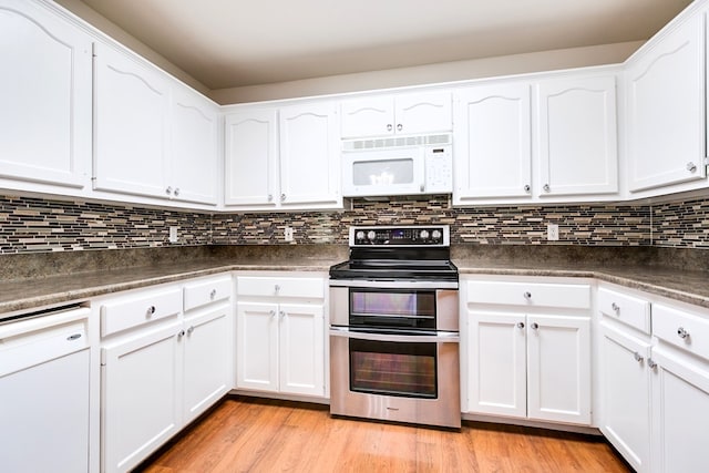 55 Southridge Dr, San Angelo, TX 76904 - kitchen featuring white appliances, dark countertops, and white cabinetry