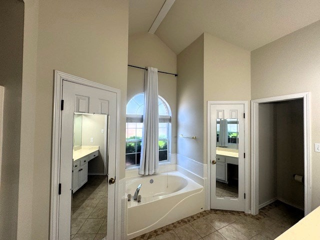 55 Southridge Dr, San Angelo, TX 76904 - bathroom with high vaulted ceiling, vanity, a garden tub, and tile patterned floors