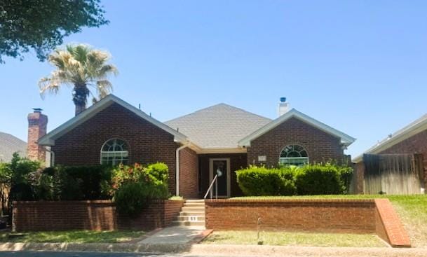 55 Southridge Dr, San Angelo, TX 76904 - view of front of home featuring brick siding and a chimney